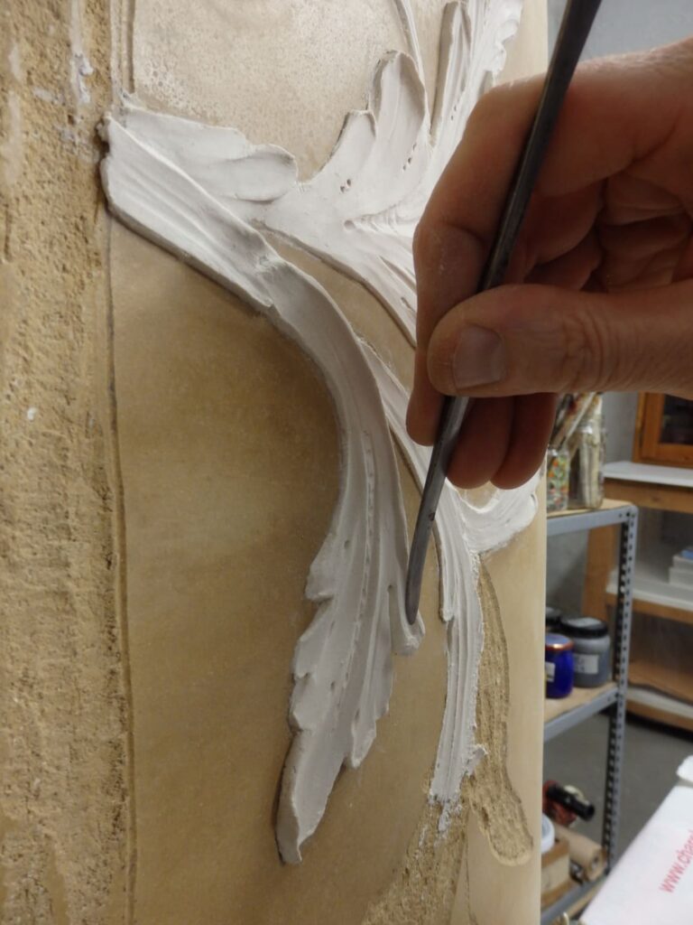 This mascherone motif with acanthus leaf ornament in bas-relief mamorino was sculpted by hand for an overmantle piece.